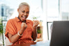 A woman looking happy at her desk at work